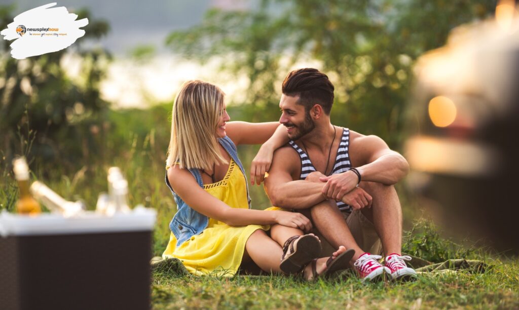 A charming and lovely couple is sitting in a garden in the moonlight.