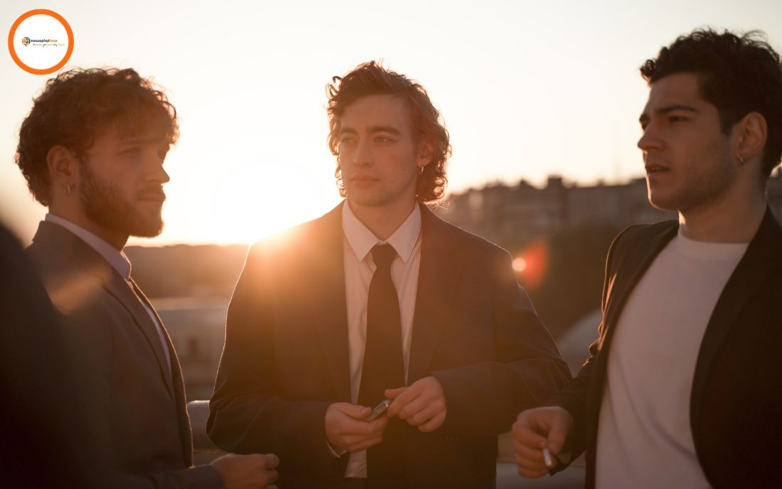 Three men are showing off their suits.