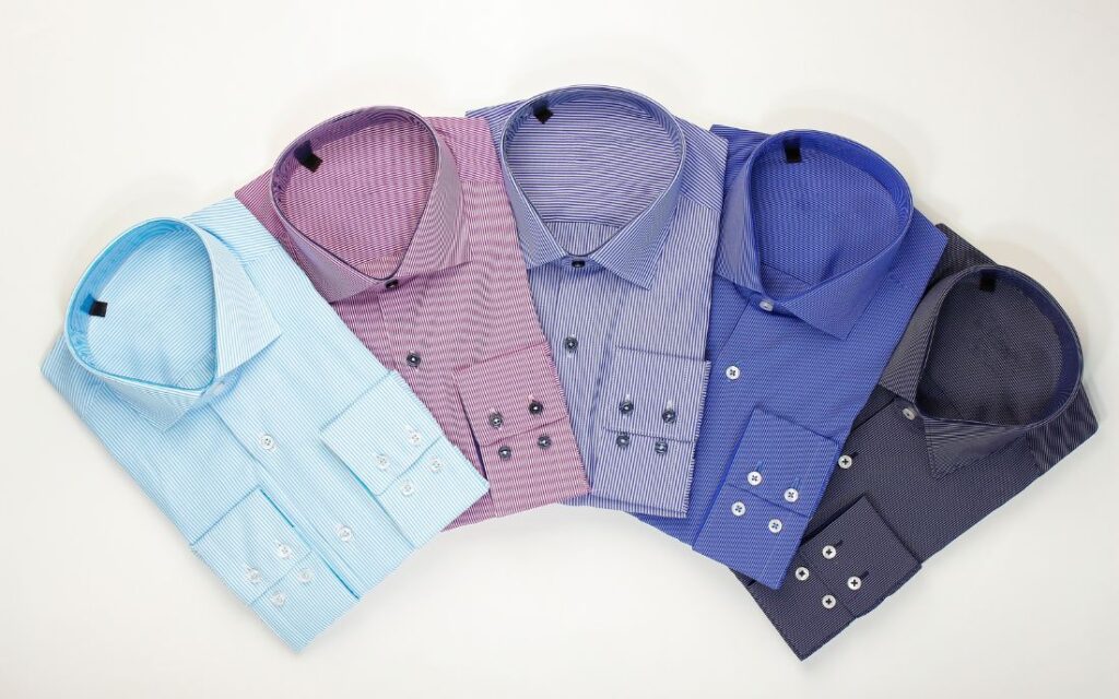 Casual shirts in multiple colors are displayed on a white background.