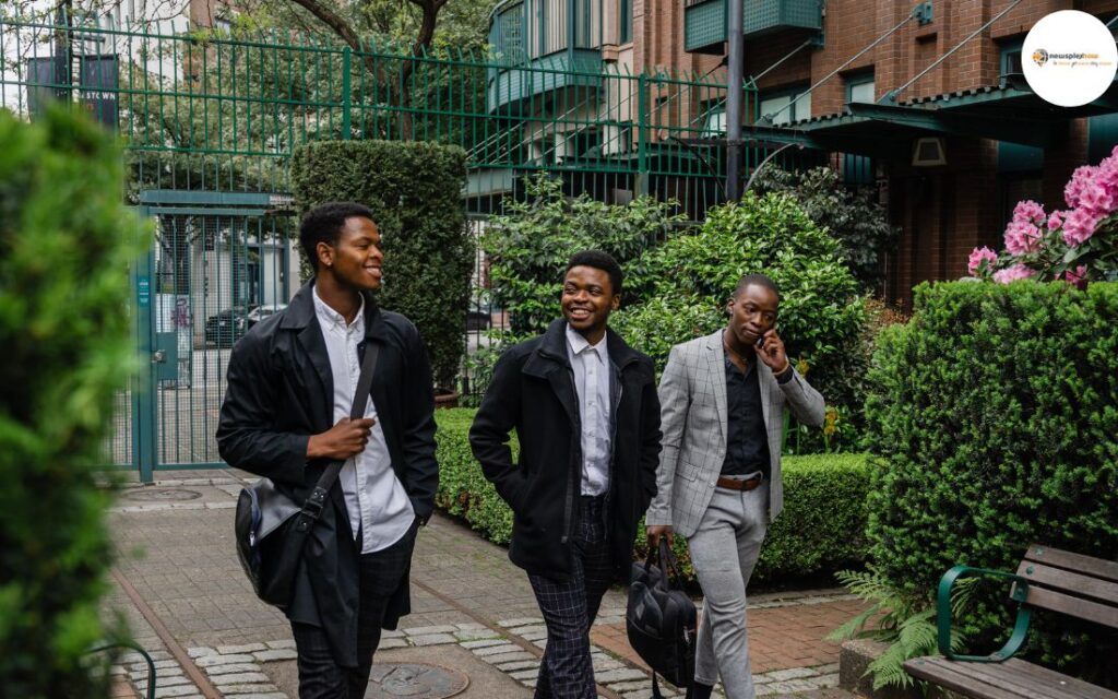 Three men are walking and showing off their business attire